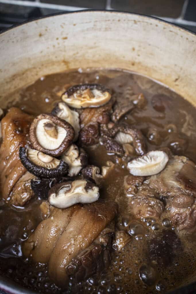 7 Eggs in pork hock stew in a pot.