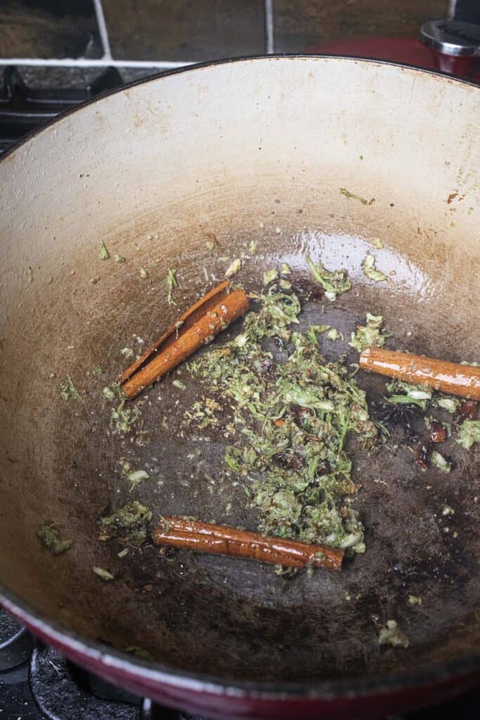 Thai Khao Ka Moo seasoning and cinnamon sticks frying in pot. 