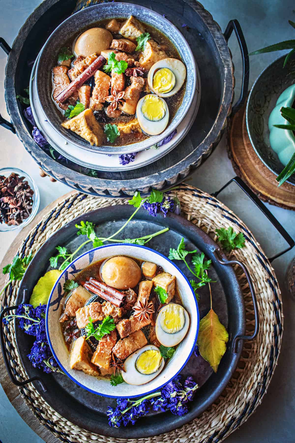 2 bowls of pork belly stew on a table 