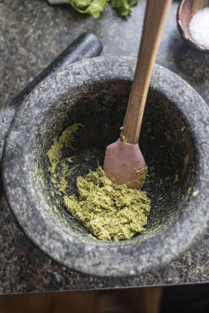 Thai green seasoning paste in a mortar.