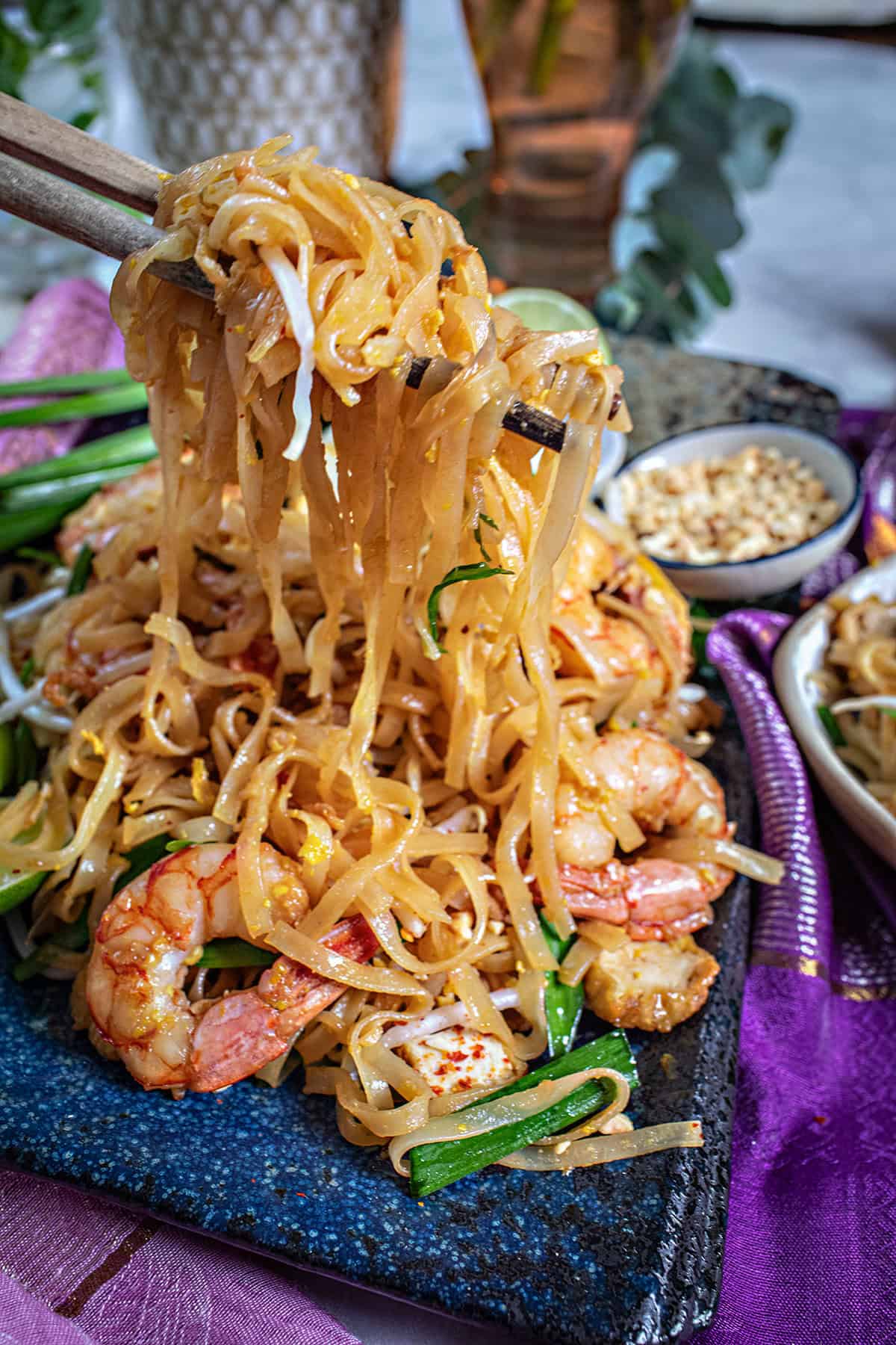 Chop sticks lifting pad thai noodles. 