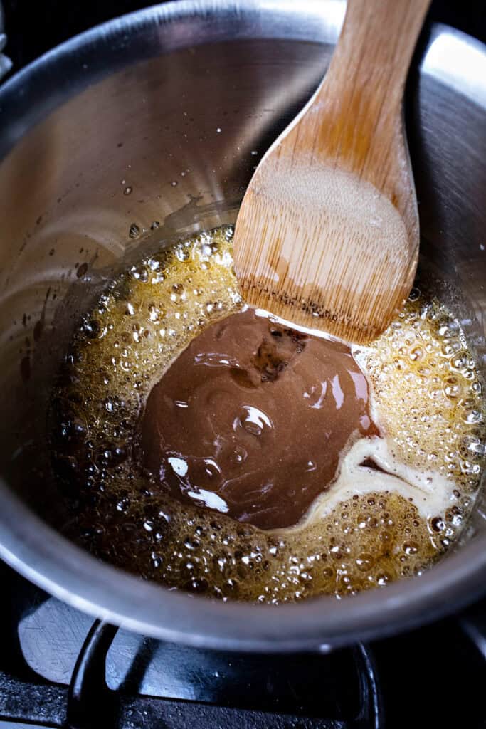 Tamarind in pad thai sauce in a sauce pan.