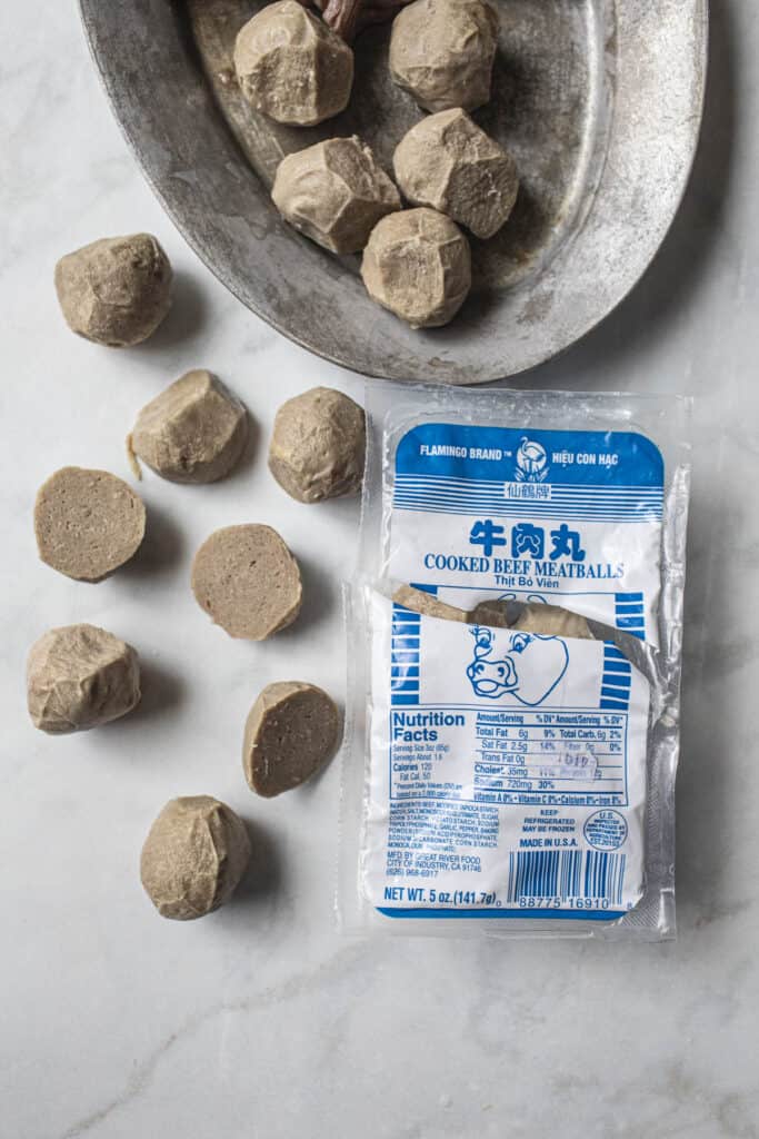 Several pieces of meat balls on a counter.