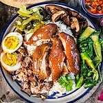Khao Khao Moo on a platter with garnishes.