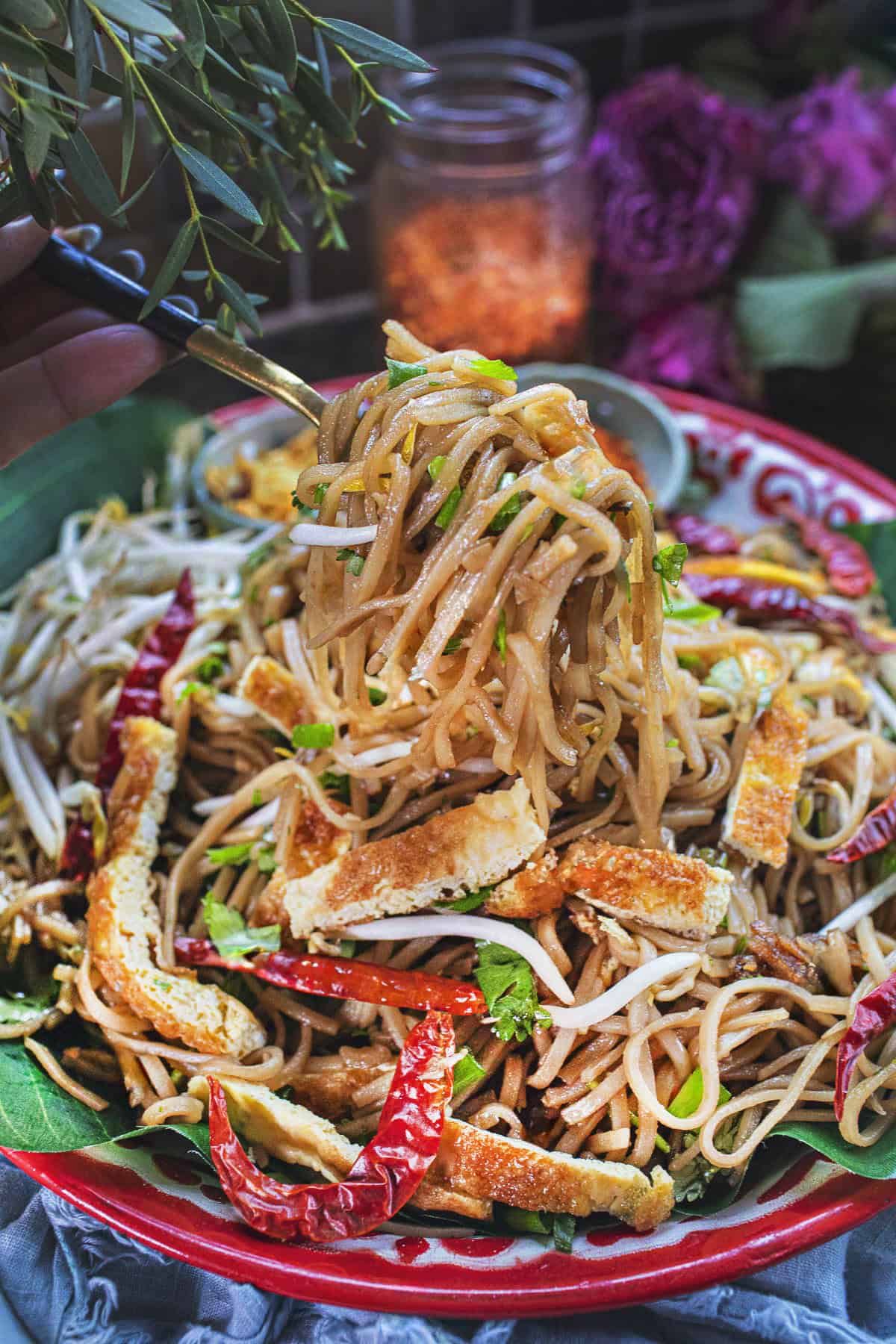 Fork lifting khua mee noodles from a platter. 