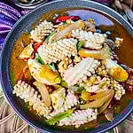 Thai salted egg with squid stir fry on a plate.