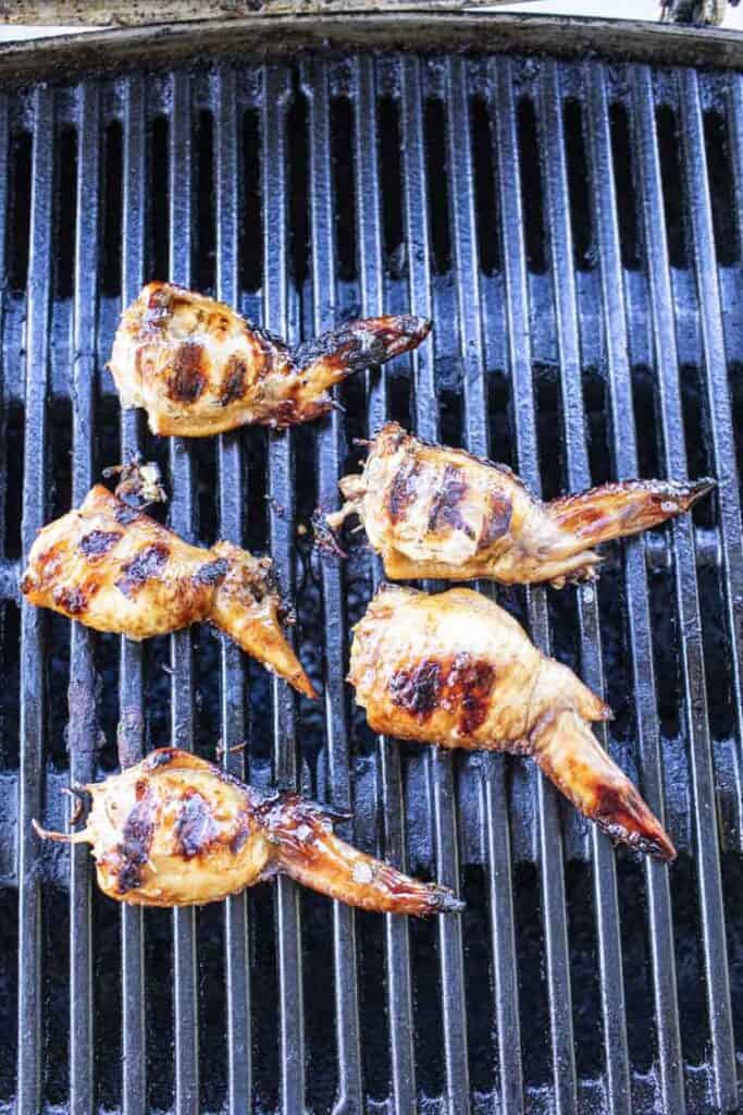 stuffed wings on a grill.