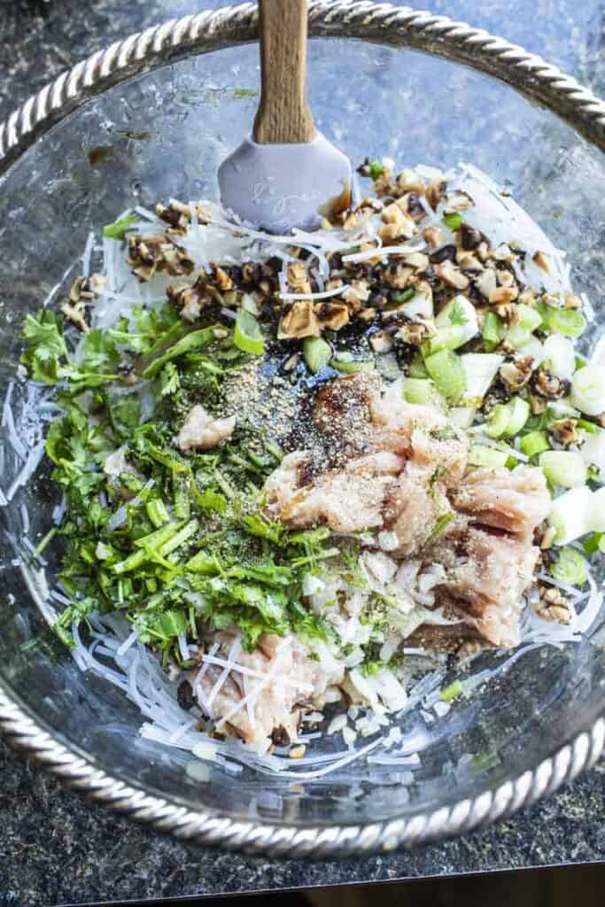Thai stuffed chicken wing mixture with green herbs in a bowl. 
