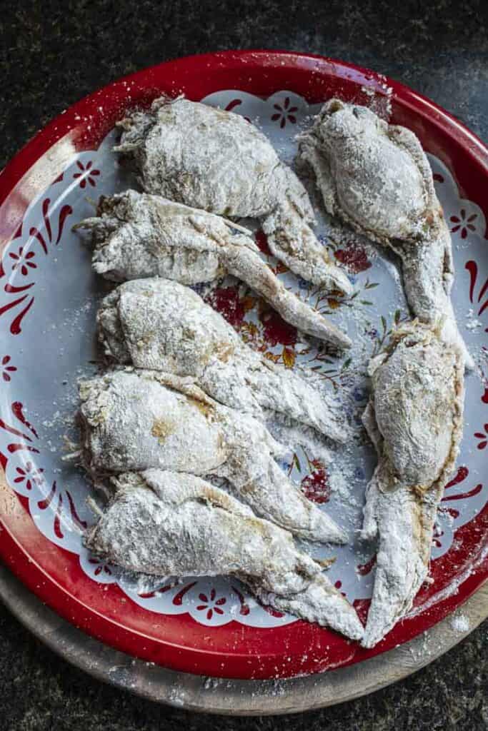 Stuffed wings with flour on a platter.