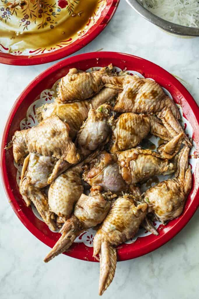 Uncooked stuffed wings on a tray.