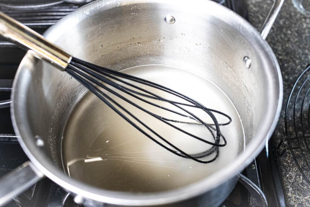 A whisk in a pan with agar powder.