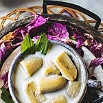 thai banana coconut milk dessert in a bowl.