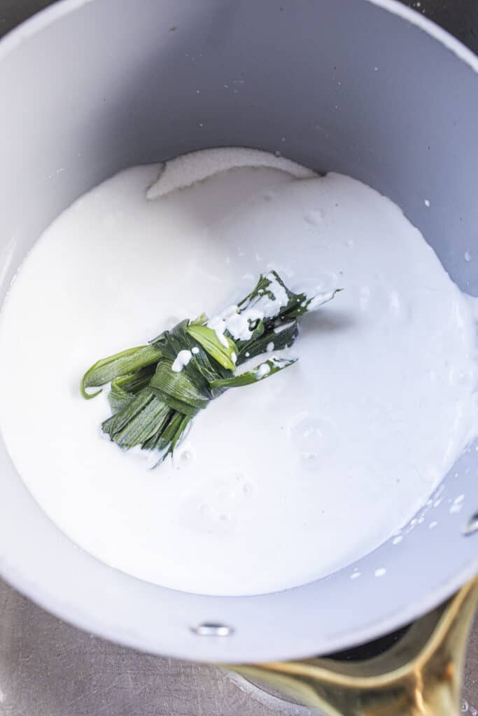 pandan leaves in coconut milk in sauce pan. 