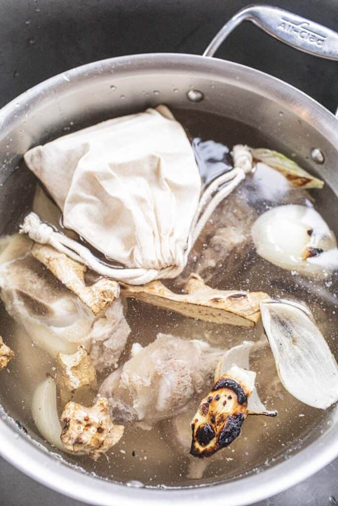 Spice sachet and toasted ginger and onion in pho broth.