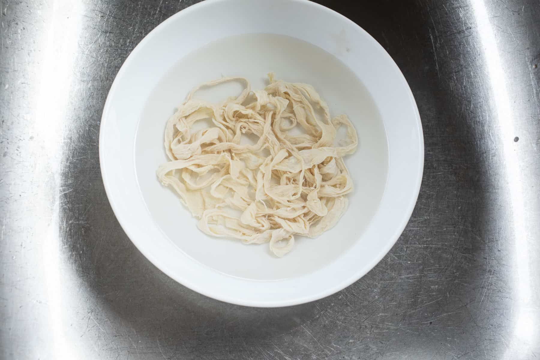 Sausage casings soaking in a bowl. 
