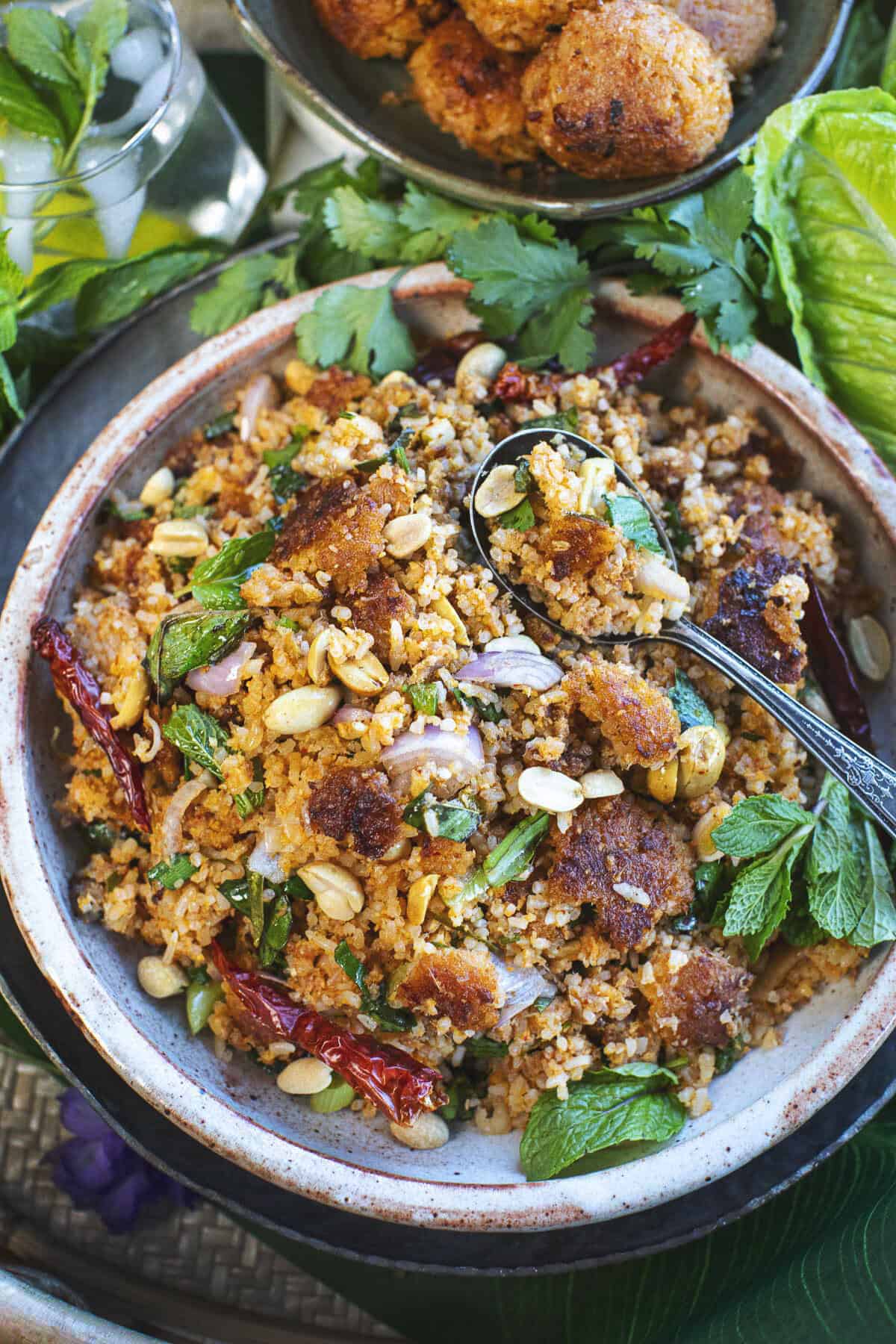 nam khao tod recipe on a plate with a spoon.