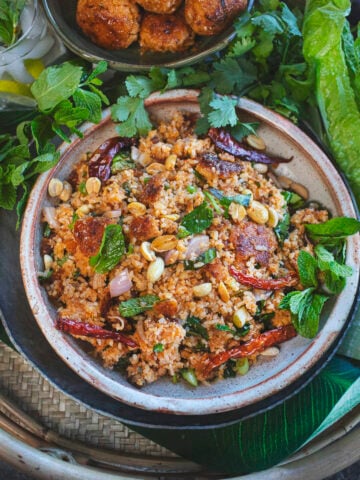 nam khao tod crispy rice salad in a bowl.