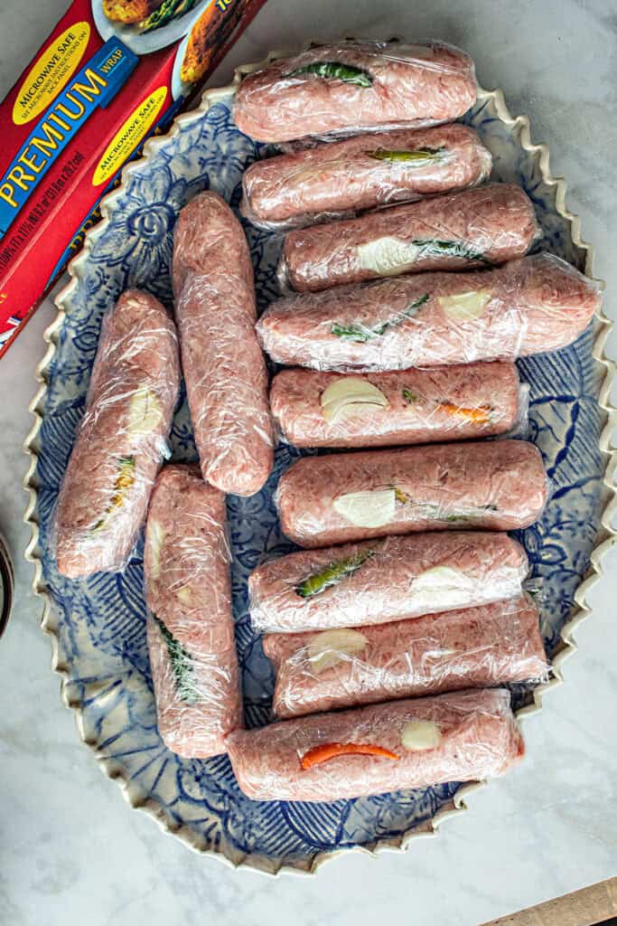 wrapped lao sausages on a tray. 