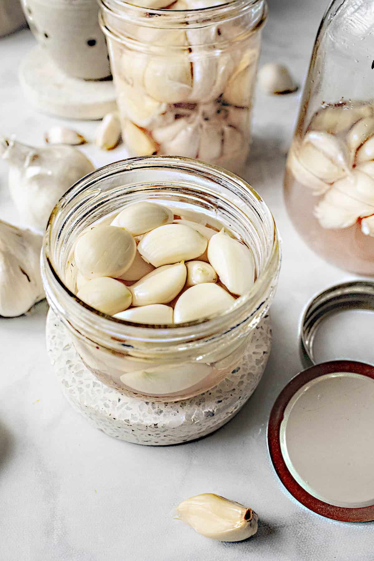 Thai pickled garlic kratiem dong in a glass jar on the table. 