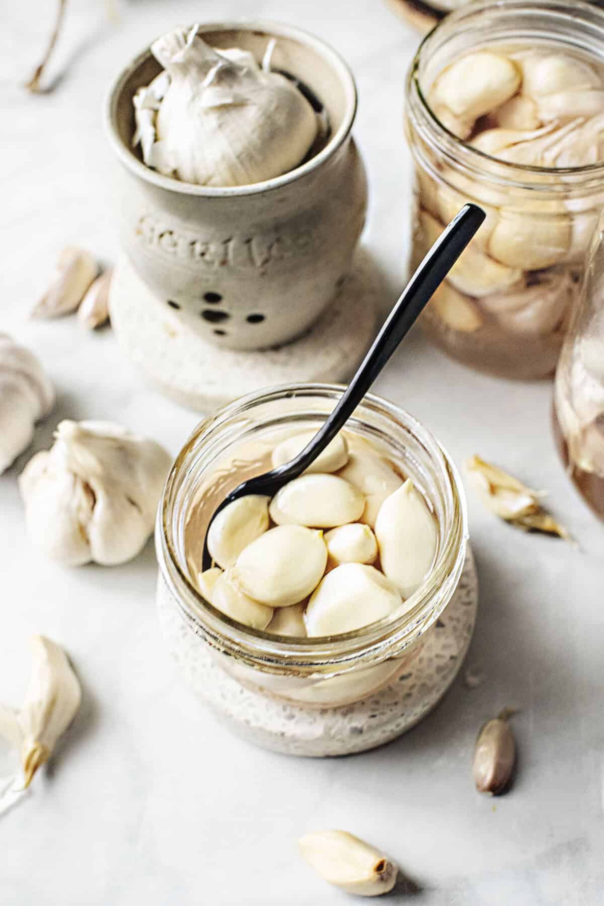 pickled garlic kratiem dong in a jar with a spoon.