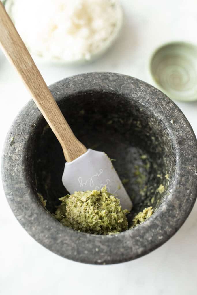 Thai green paste in a mortar with a spatula. 