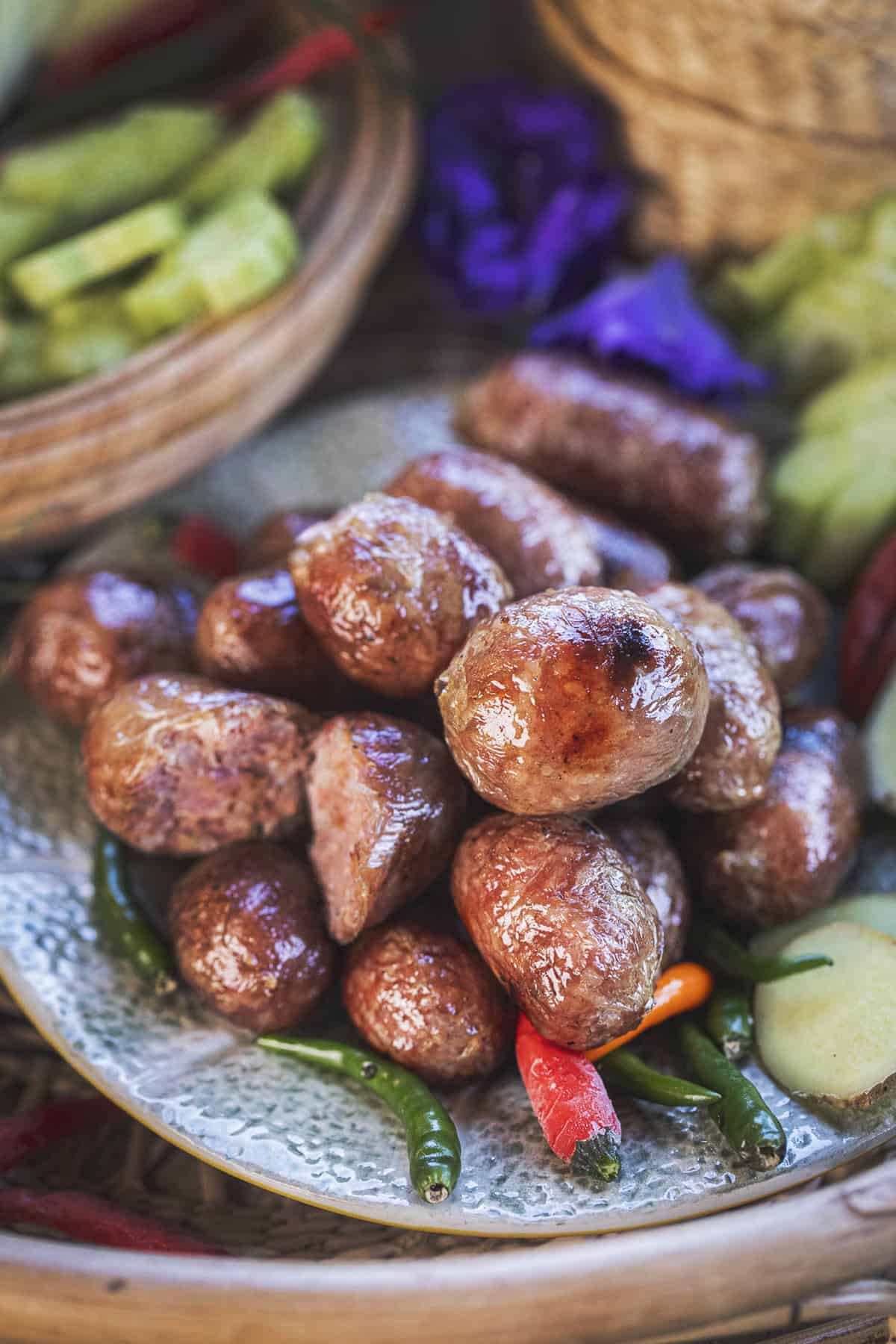 thai pork sausage on a plate with peppers.