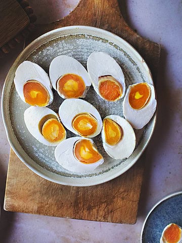 cooked and sliced salted eggs on a plate.