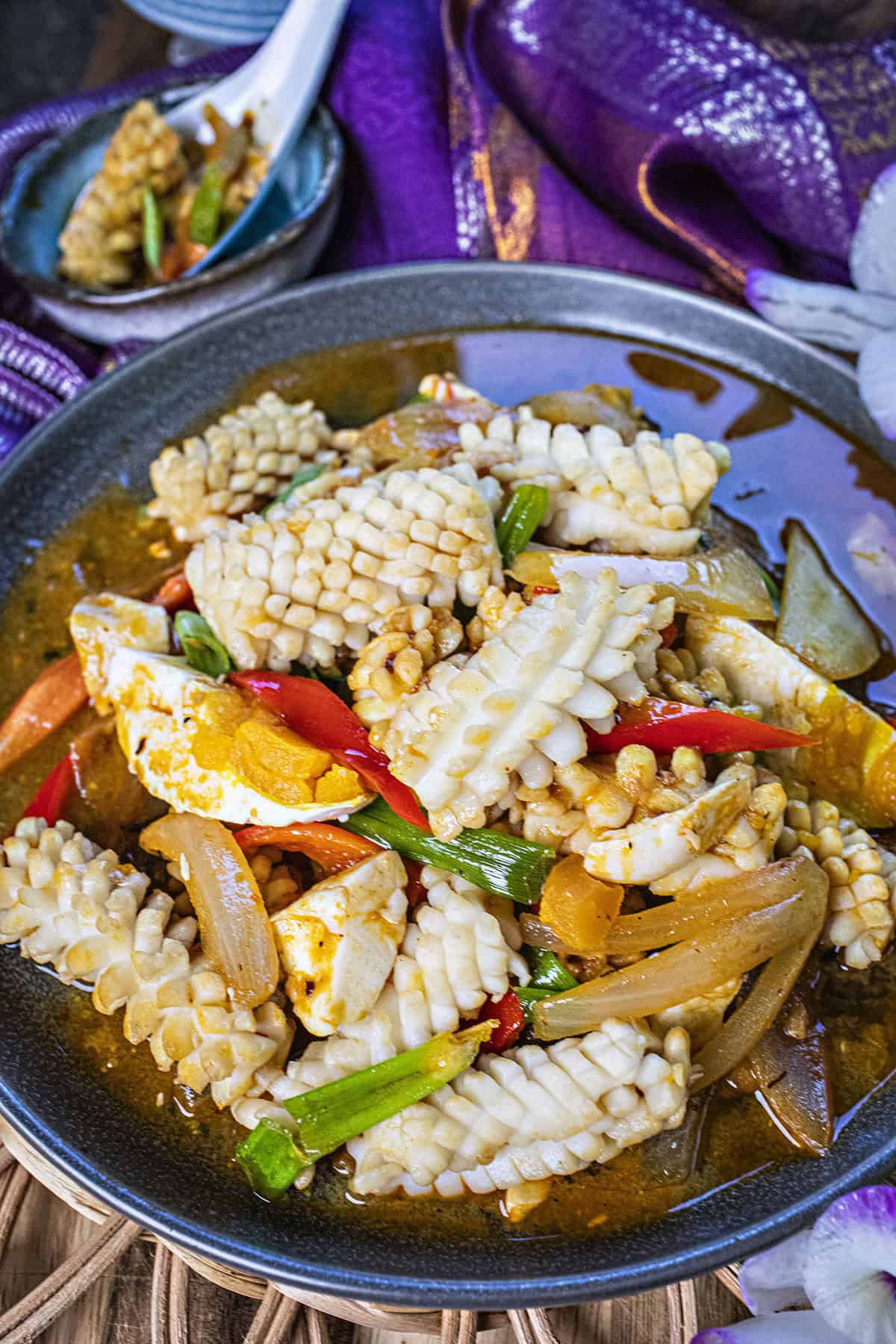 Close up of Thai salted egg squid stir fry on a plate. 