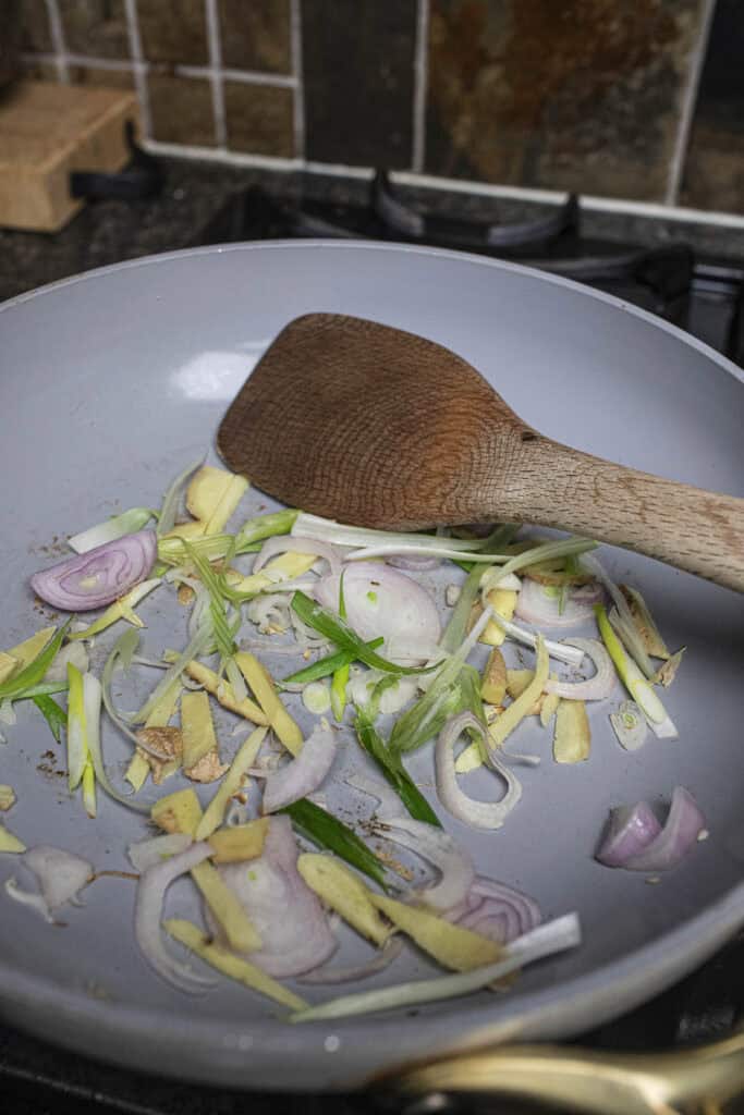 Aromatics sauteing in a pan.
