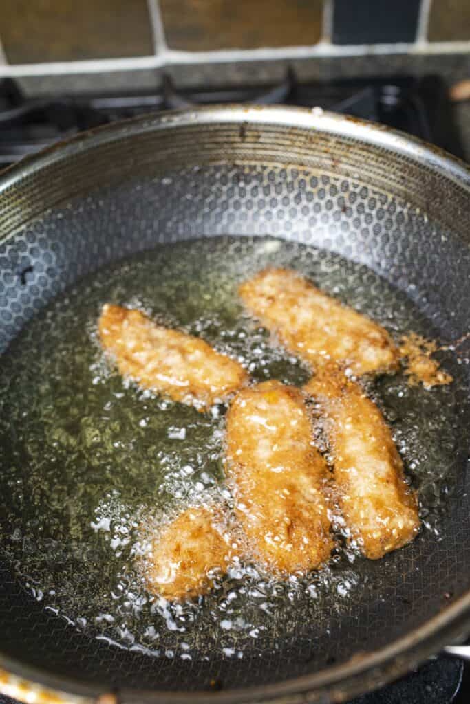 
fried bananas in hot oil in a wok.