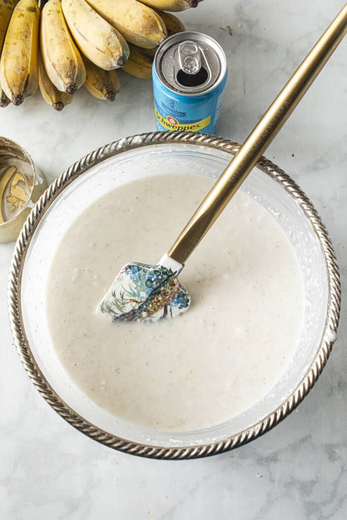 Banana batter in a bowl with spatula.