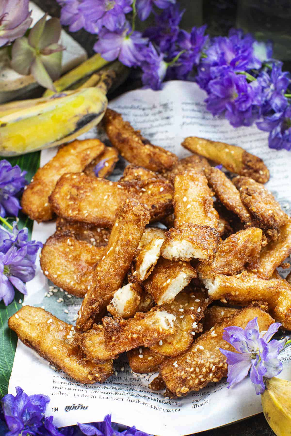 thai banana fritters on a newspaper. 