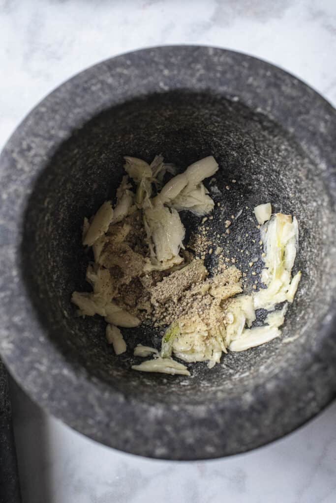 Garlic and pepper in a stone mortar.