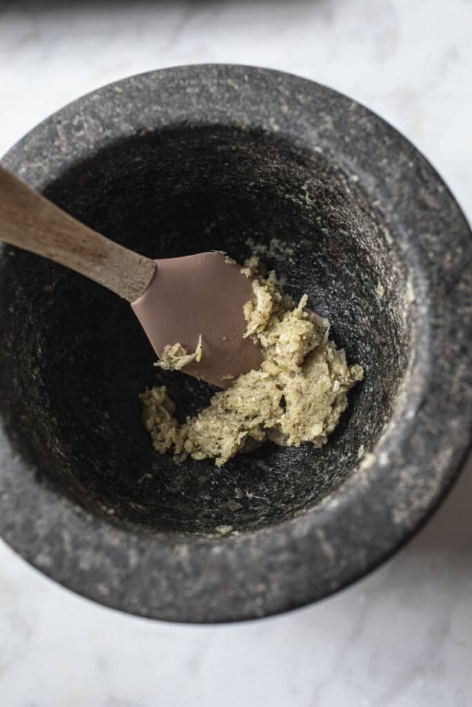 Garlic and pepper paste in a stone mortar.