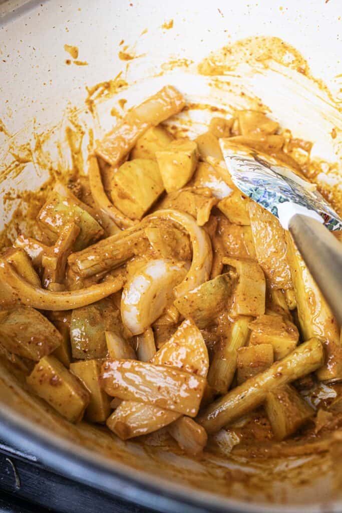 Vegetables with curry sauce ilk in a pot.