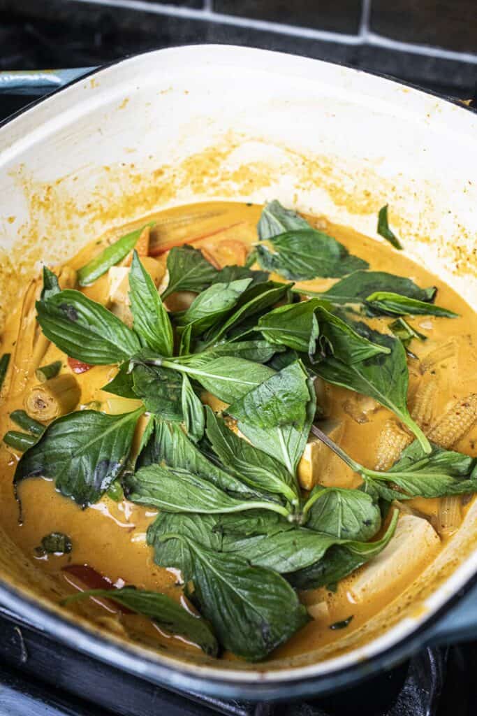 Thai red curry with basil in a pot.