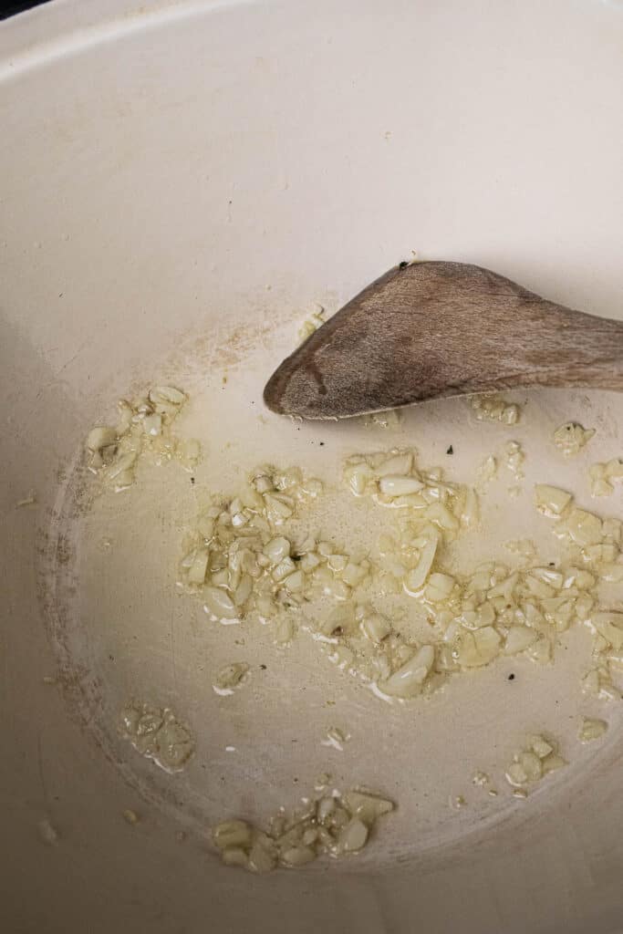 Diced garlic in a pot on the stove. 