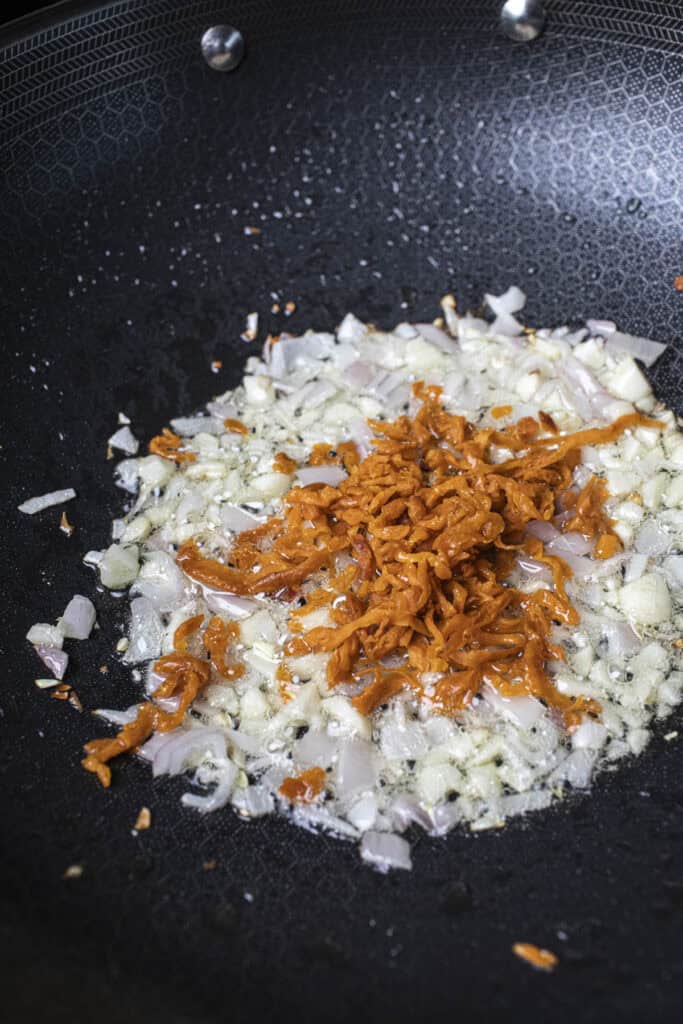 Fried aromatics in a wok with oil. 