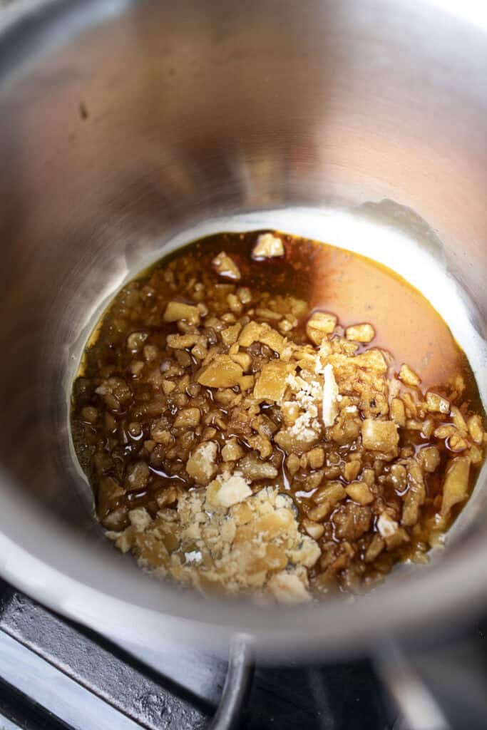 Sugar and soy sauce in a sauce pan. 