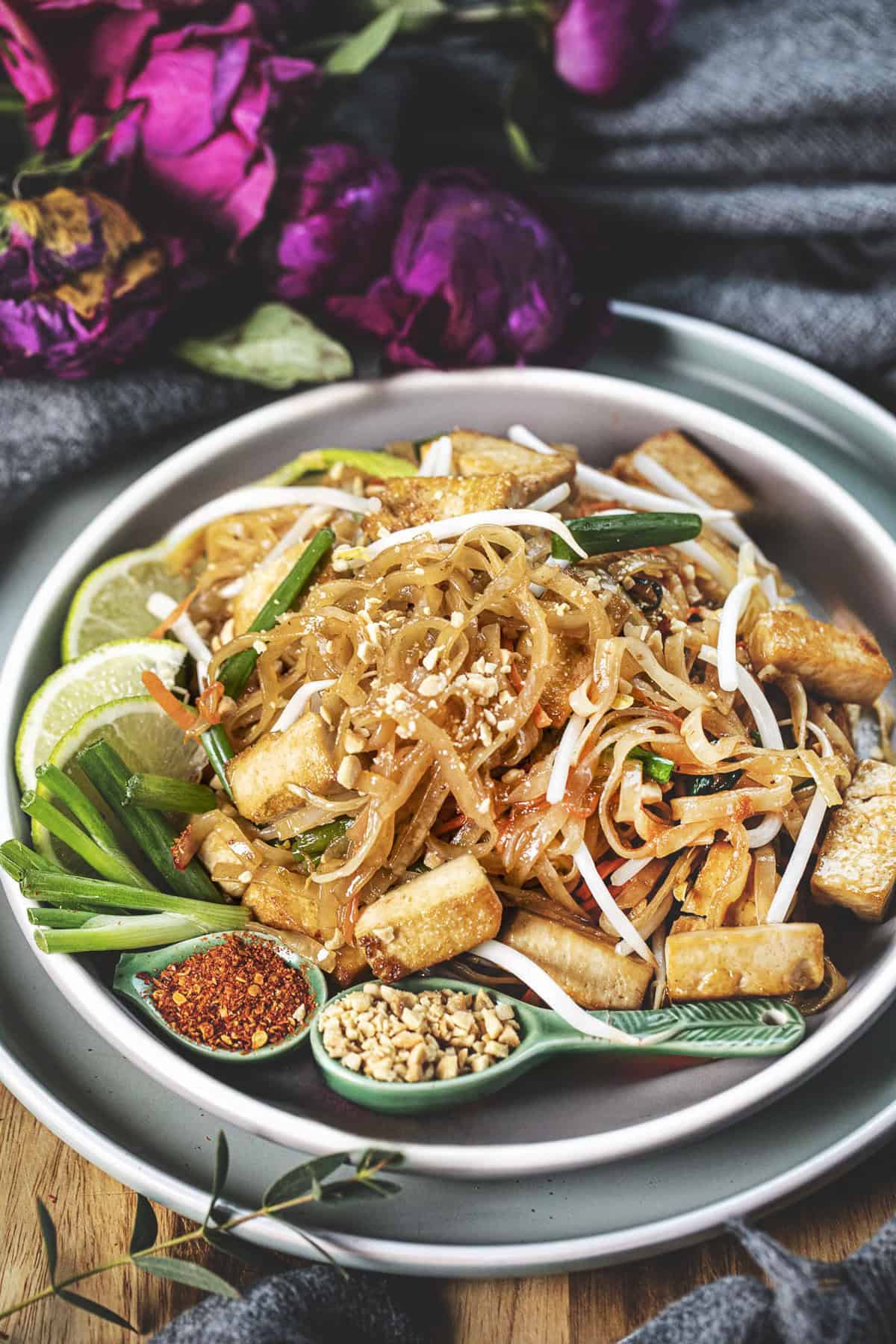Vegan pad thai noodles in a plate on the table. 