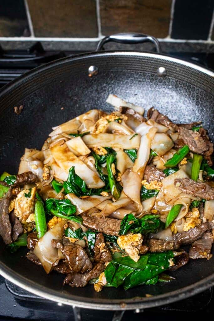 pad see ew stir fry in a wok.