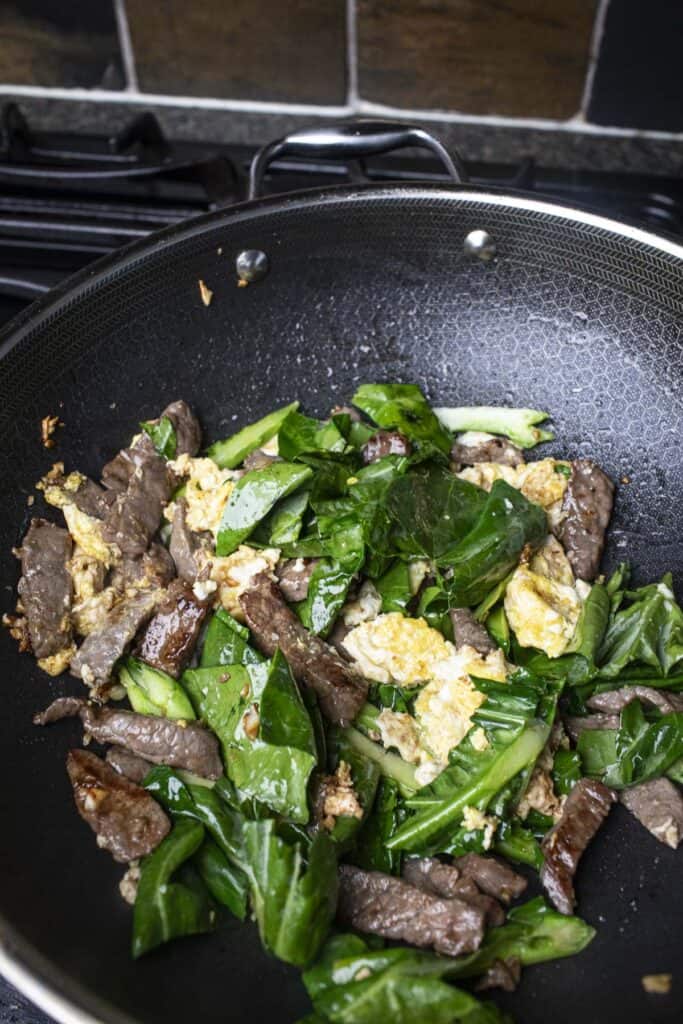 Pad see ew beef and Chinese broccoli in a wok.