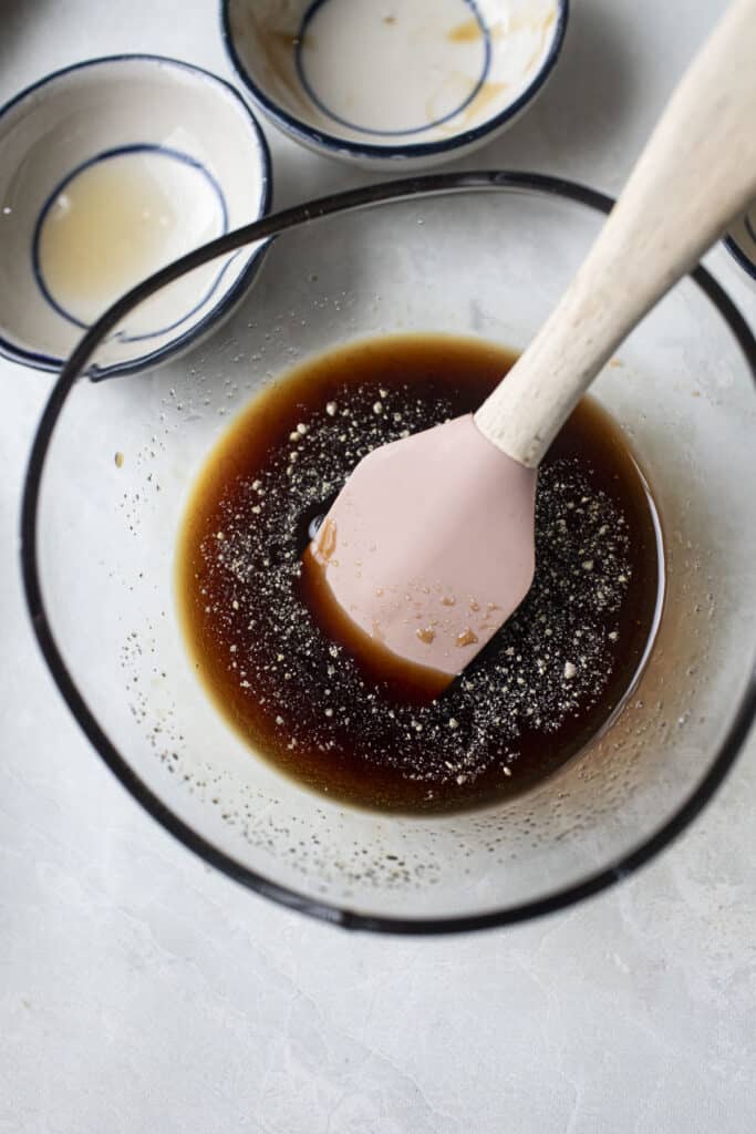 pad see ew sauce in a bowl with spatula. 