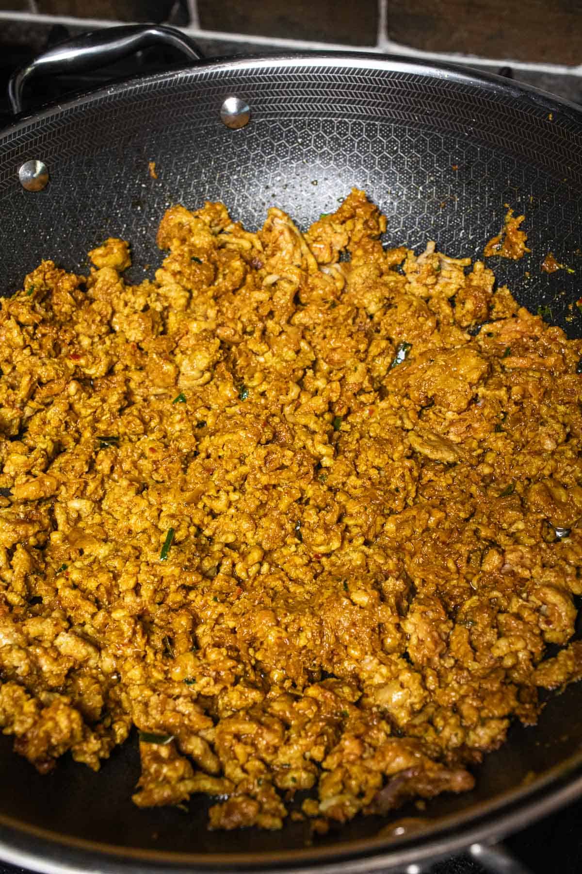 khua kling moo or ground pork frying in a wok. 