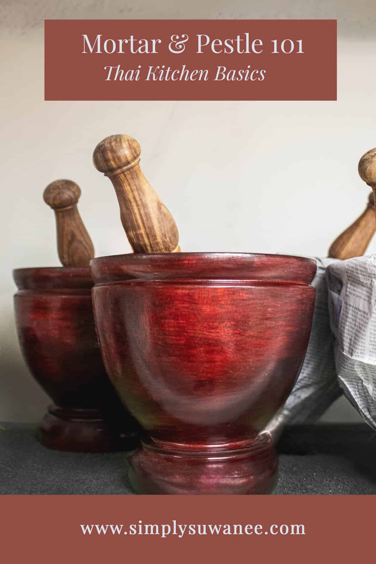 2-3 sets of Red wooden lao mortar and pestle on a shelf.