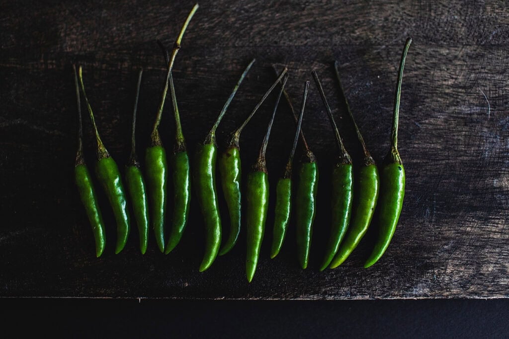 Thai green peppers on a board.