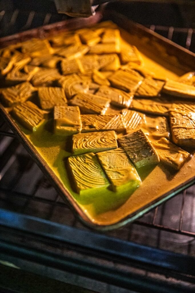 Baked tofu satay on a tray in the oven