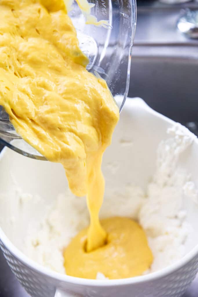 Mango ice cream base is poured into a bowl or whipped cream. e. 
