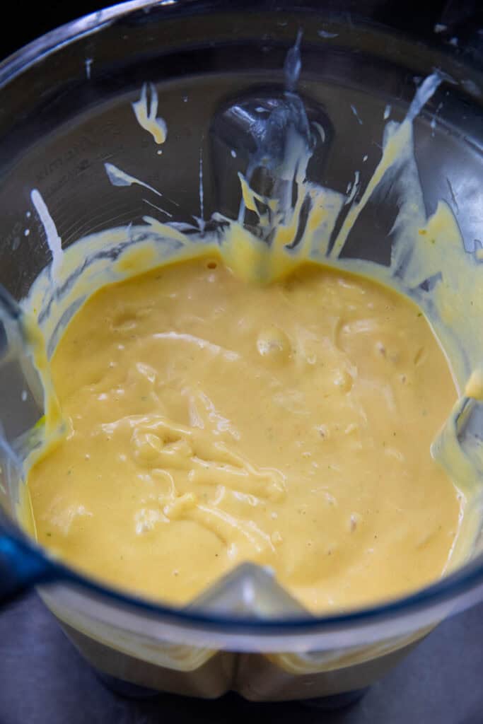 Creamy yellow mango ice cream base in a blender. 