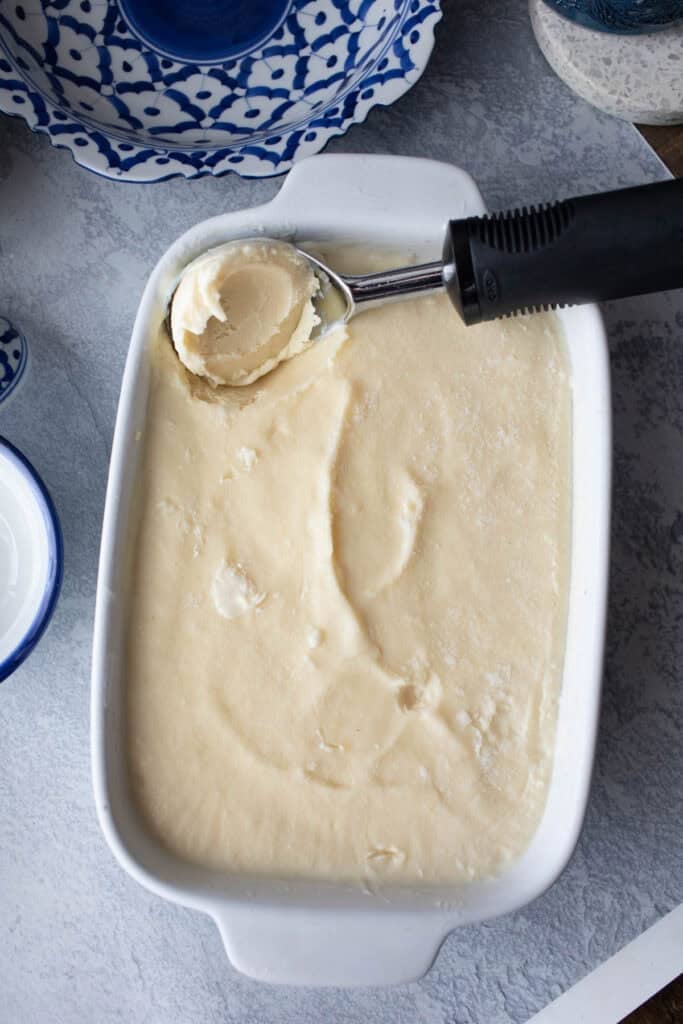 Frozen Durian ice cream in a shallow pan on a table.